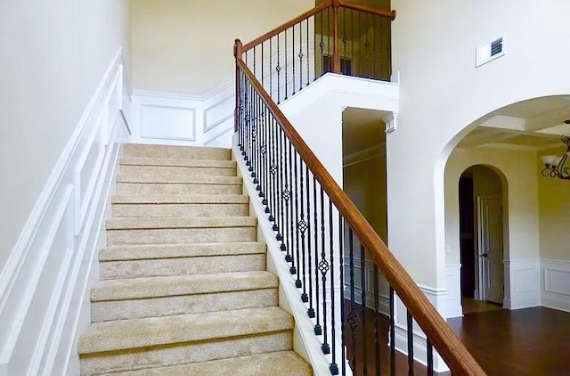 1139 Prides Xing, Aiken, SC 29801 - stairs featuring a decorative wall, wainscoting, arched walkways, and wood finished floors