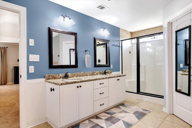 945 Watermark Dr, Evans, GA 30809 - full bathroom featuring a shower stall, wainscoting, double vanity, and tile patterned flooring