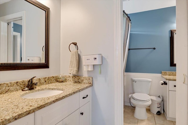 945 Watermark Dr, Evans, GA 30809 - bathroom featuring toilet, vanity, wainscoting, tile patterned flooring, and curtained shower