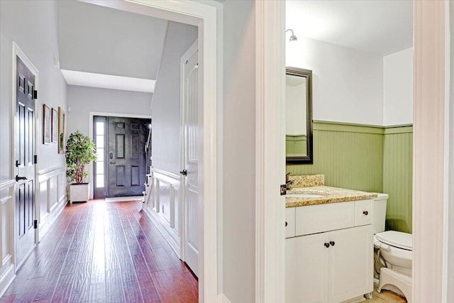 945 Watermark Dr, Evans, GA 30809 - bathroom featuring wainscoting, toilet, wood finished floors, a decorative wall, and vanity