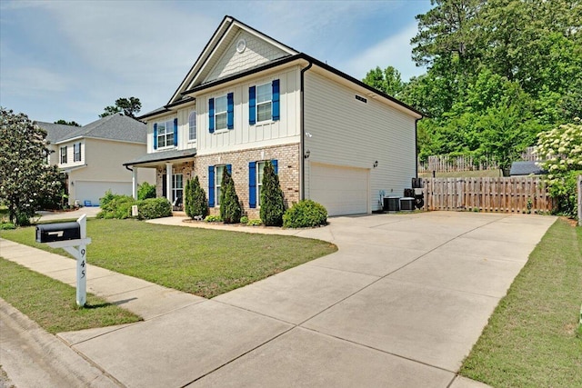 945 Watermark Dr, Evans, GA 30809 - view of front of home featuring board and batten siding, brick siding, an attached garage, central AC, and concrete driveway