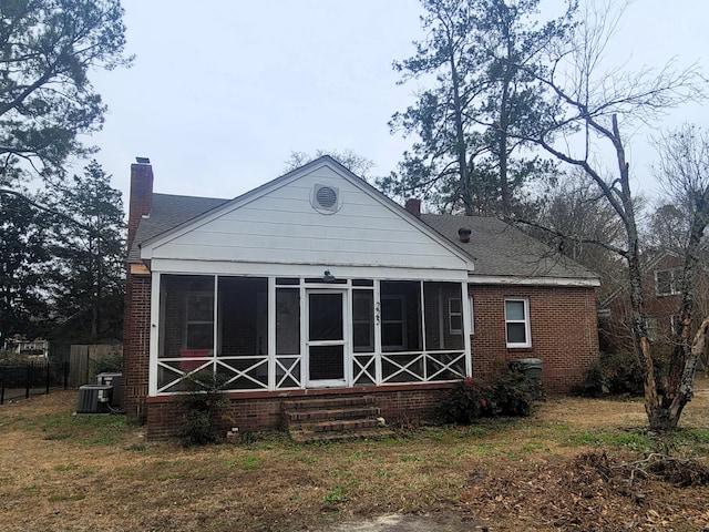 back of house with a sunroom and cooling unit