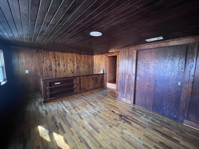 basement with hardwood / wood-style flooring, wood ceiling, and wooden walls