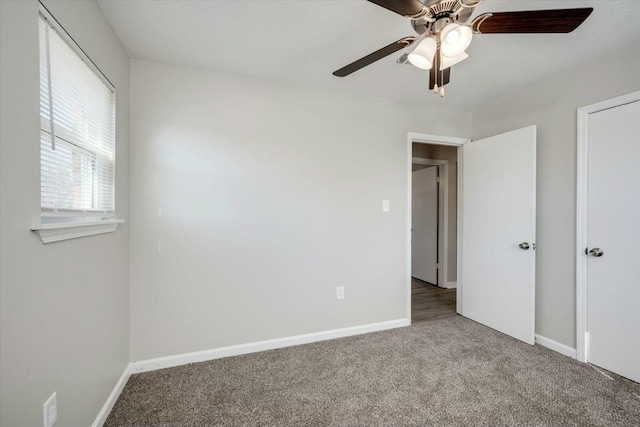 unfurnished bedroom with ceiling fan and carpet flooring