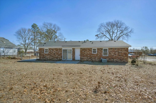 rear view of house with a lawn, a patio area, and central AC