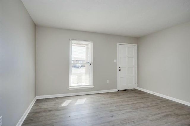 unfurnished room with light hardwood / wood-style floors