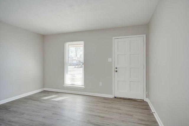 empty room with light hardwood / wood-style flooring