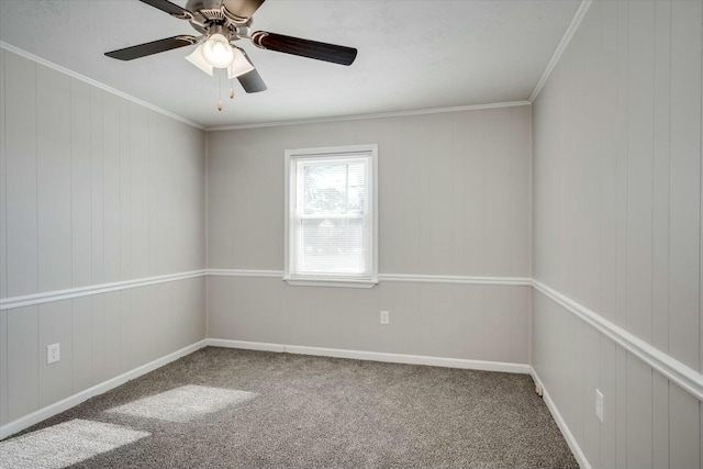 carpeted empty room with ceiling fan and ornamental molding