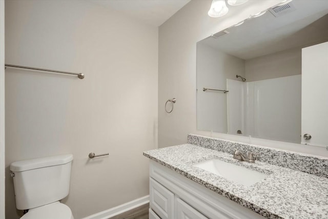 bathroom featuring vanity, toilet, a shower, and hardwood / wood-style flooring