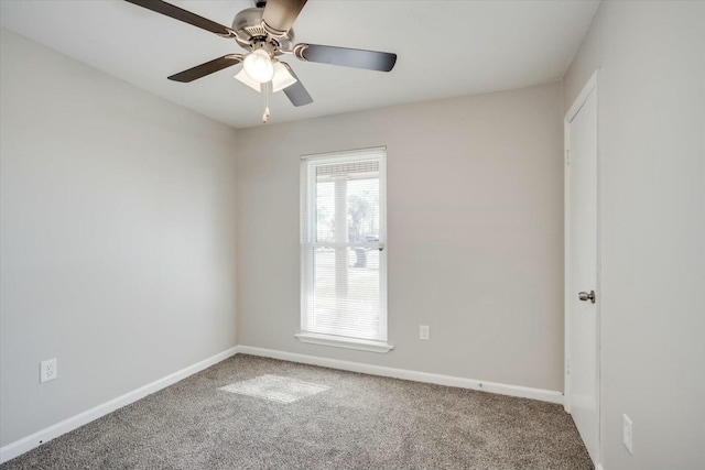 carpeted spare room featuring ceiling fan