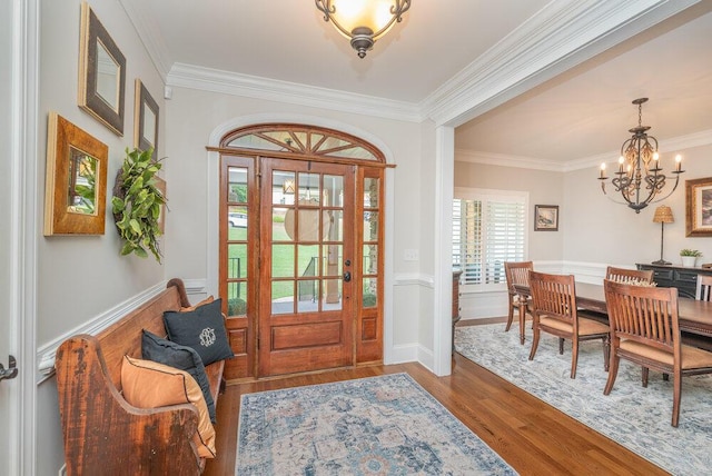 295 River Wind Dr, North Augusta, SC 29841 - entryway featuring wood finished floors, a chandelier, crown molding, and wainscoting