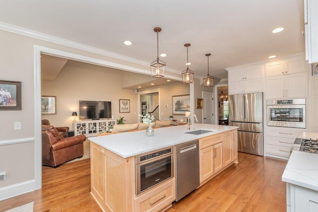 295 River Wind Dr, North Augusta, SC 29841 - kitchen with appliances with stainless steel finishes, open floor plan, crown molding, light wood-style floors, and a center island with sink