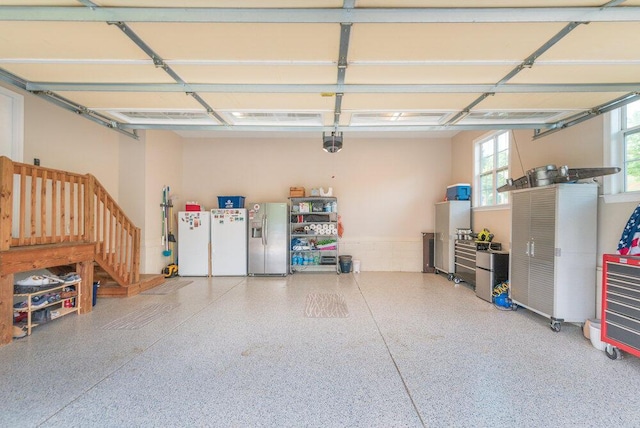 295 River Wind Dr, North Augusta, SC 29841 - garage with a garage door opener, stainless steel fridge with ice dispenser, and freestanding refrigerator