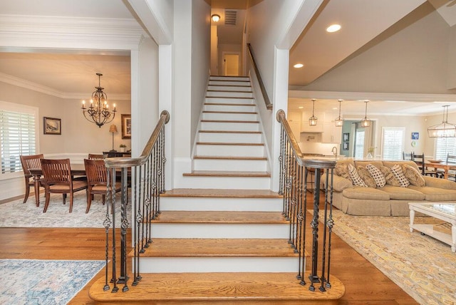 295 River Wind Dr, North Augusta, SC 29841 - stairs with a chandelier, wood finished floors, ornamental molding, and recessed lighting