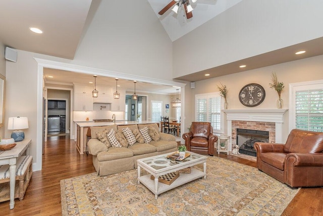295 River Wind Dr, North Augusta, SC 29841 - living area featuring healthy amount of natural light, ceiling fan, wood finished floors, high vaulted ceiling, and a fireplace