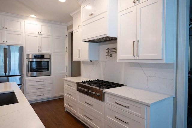295 River Wind Dr, North Augusta, SC 29841 - kitchen with appliances with stainless steel finishes, white cabinetry, decorative backsplash, light stone countertops, and recessed lighting