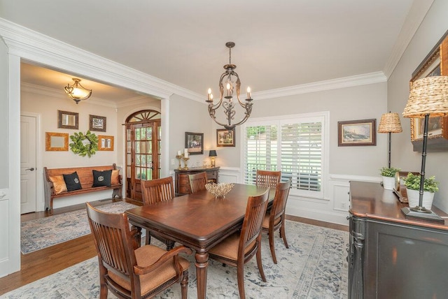 295 River Wind Dr, North Augusta, SC 29841 - dining area with ornamental molding, a chandelier, plenty of natural light, light wood-type flooring, and a wainscoted wall