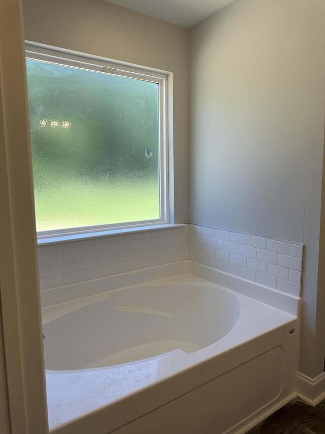 1457 Elias Sta, Thomson, GA 30824 - bathroom featuring a tub and hardwood / wood-style floors