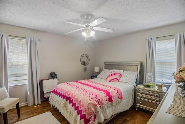 bedroom with a textured ceiling, dark hardwood / wood-style floors, and ceiling fan