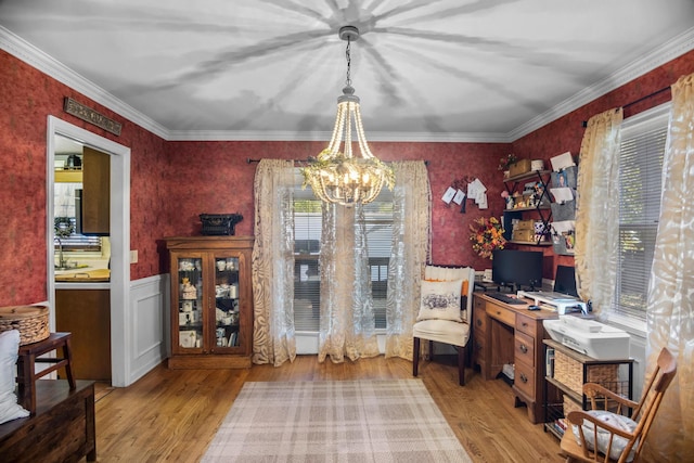 dining room with a chandelier, light wood-type flooring, and ornamental molding