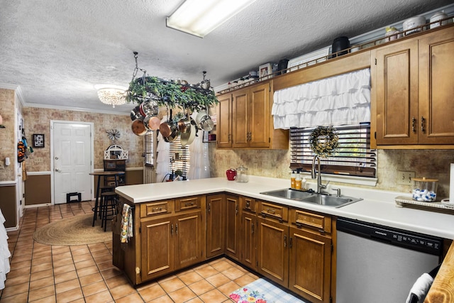 kitchen featuring kitchen peninsula, light tile patterned floors, stainless steel dishwasher, and sink