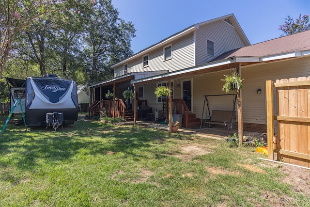 back of house with a lawn