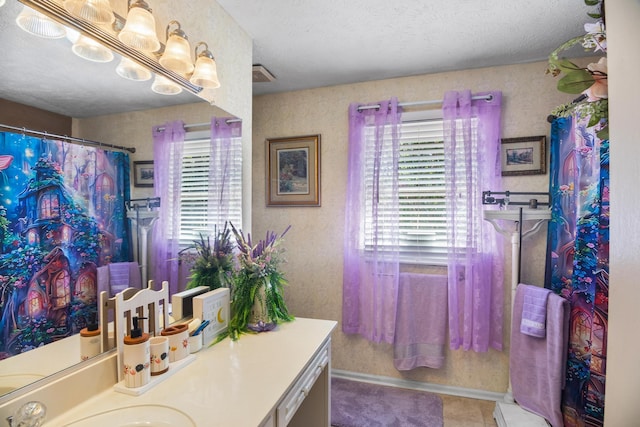 bathroom with vanity, a textured ceiling, and tile patterned floors