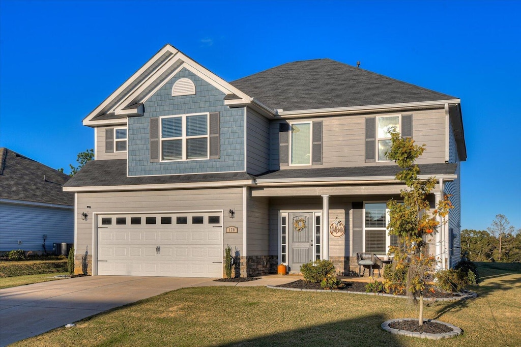 view of front of property with a front yard and a garage