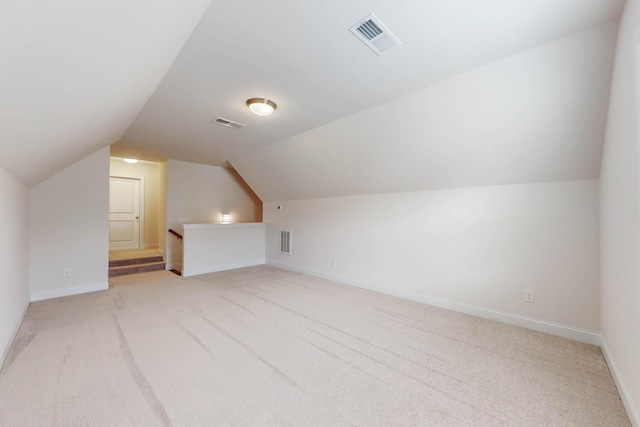 additional living space with light carpet and lofted ceiling