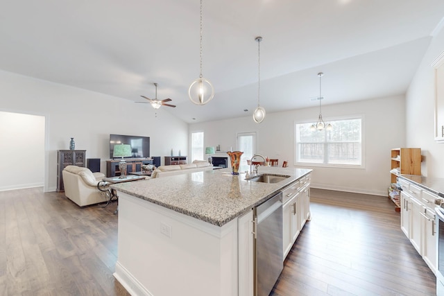 kitchen with stainless steel dishwasher, sink, a center island with sink, white cabinetry, and lofted ceiling