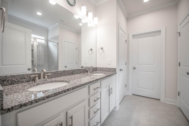 bathroom with tile patterned flooring, vanity, a shower with door, and ornamental molding