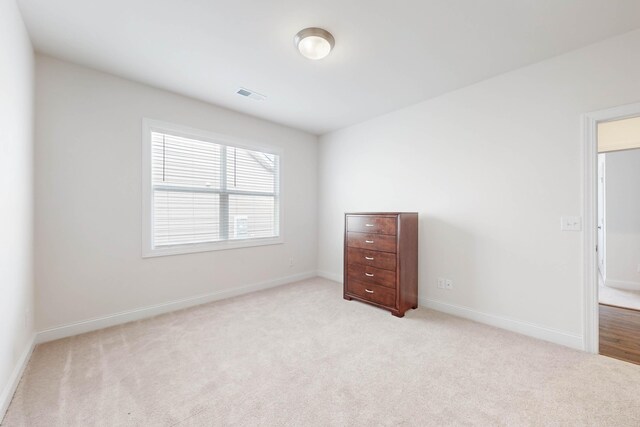 spare room with light colored carpet