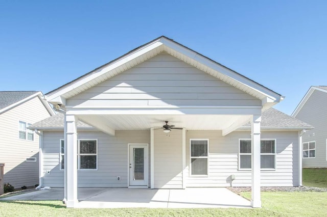 back of property featuring a lawn, ceiling fan, and a patio