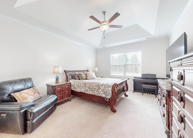 bedroom with ornamental molding, a tray ceiling, ceiling fan, and light colored carpet