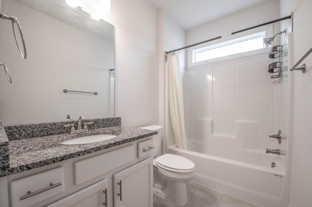 full bathroom featuring tile patterned floors, shower / bath combo with shower curtain, vanity, and toilet