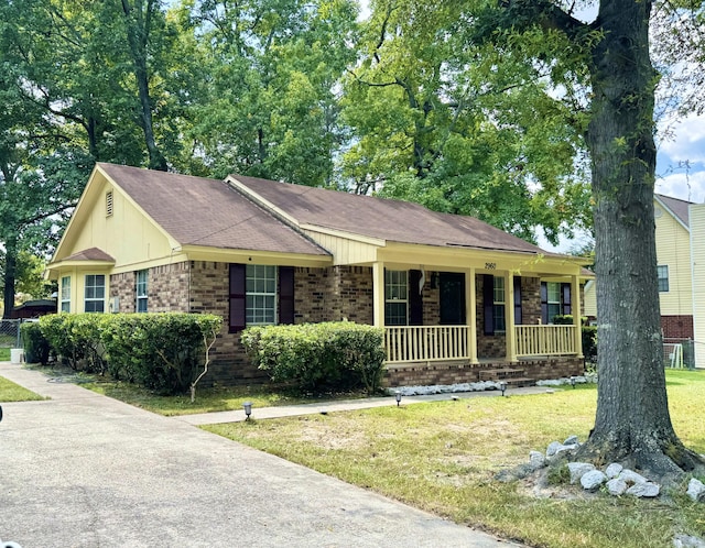 ranch-style home featuring a front yard and a porch