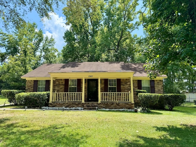 single story home with covered porch and a front yard