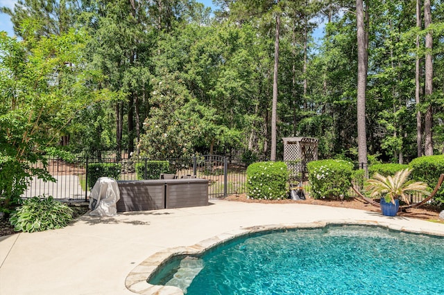 view of swimming pool featuring fence and a patio area