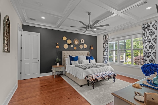 bedroom with coffered ceiling, wood finished floors, baseboards, ceiling fan, and beam ceiling