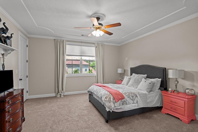 carpeted bedroom with ornamental molding, a ceiling fan, a textured ceiling, and baseboards