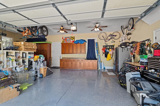 garage with a garage door opener and a ceiling fan