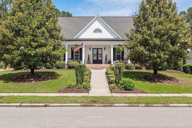 view of front facade with french doors, a porch, and a front yard