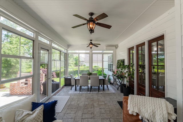 sunroom with outdoor dining space and a ceiling fan