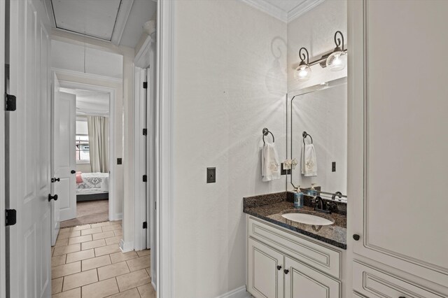 bathroom with vanity, tile patterned flooring, ornamental molding, and baseboards