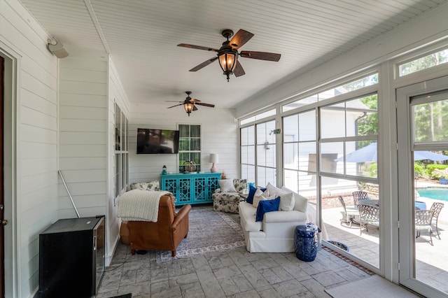 sunroom / solarium with a ceiling fan and an outdoor hangout area