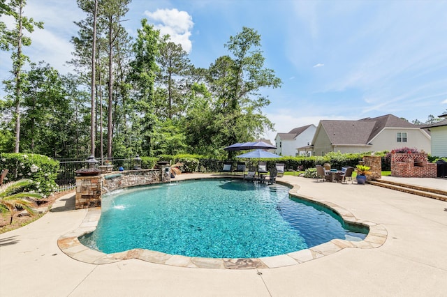 view of swimming pool with a patio area and fence