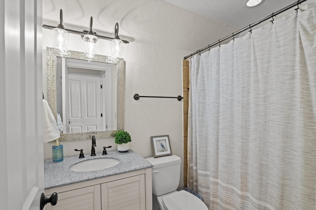 full bath featuring toilet, a textured wall, vanity, and a shower with shower curtain