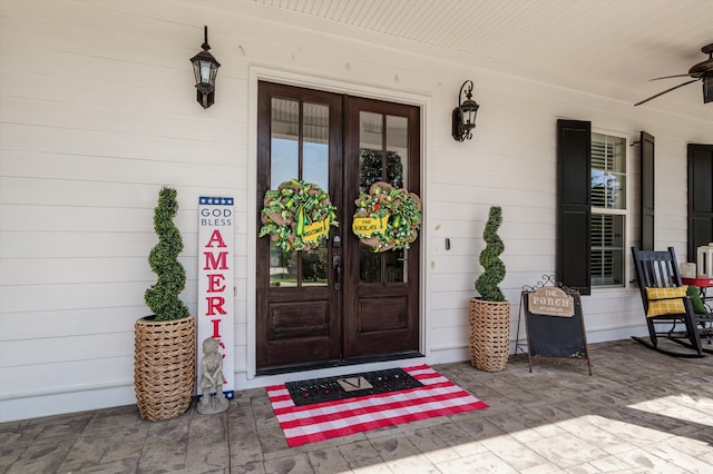 doorway to property with ceiling fan, french doors, and a porch