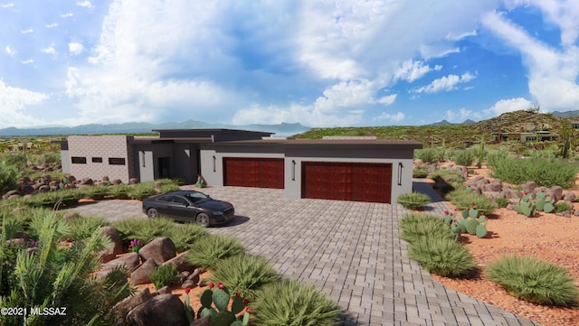 view of front facade with a mountain view and a garage