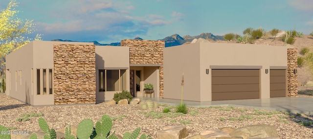 pueblo-style home featuring a mountain view and a garage